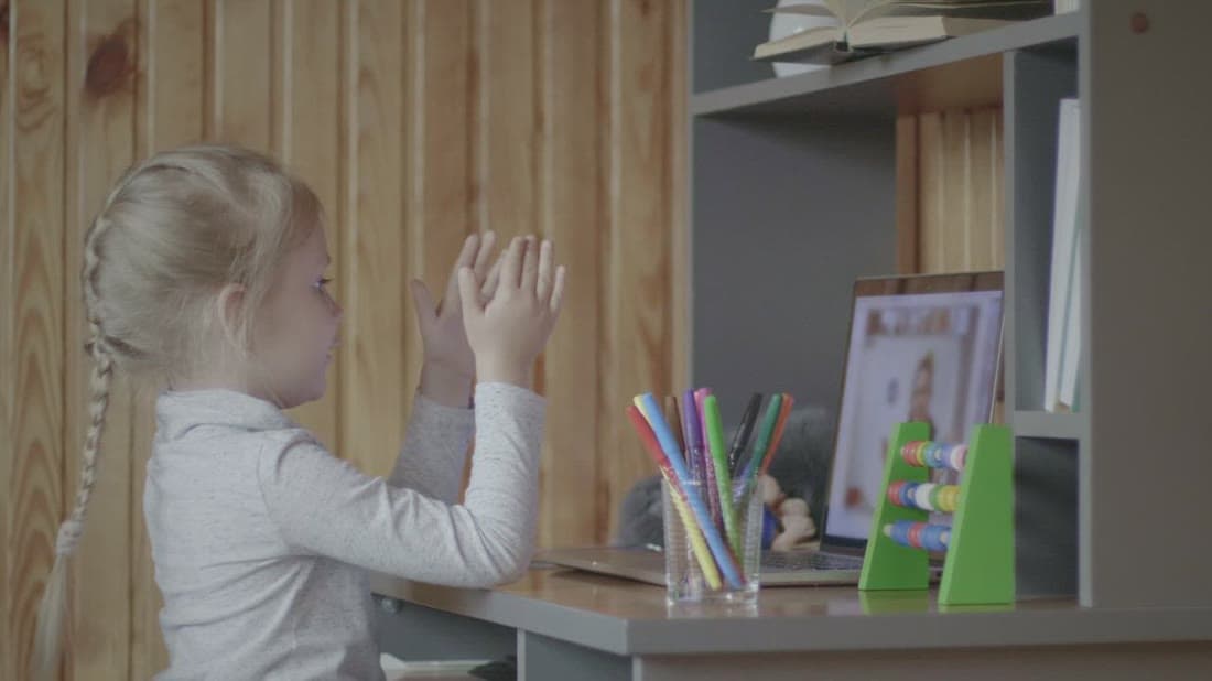 Student attending an interactive online class at home