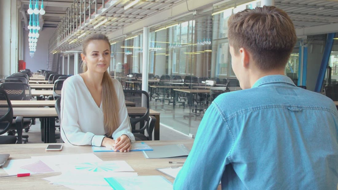 Sales team discussing customer accounts in a modern office