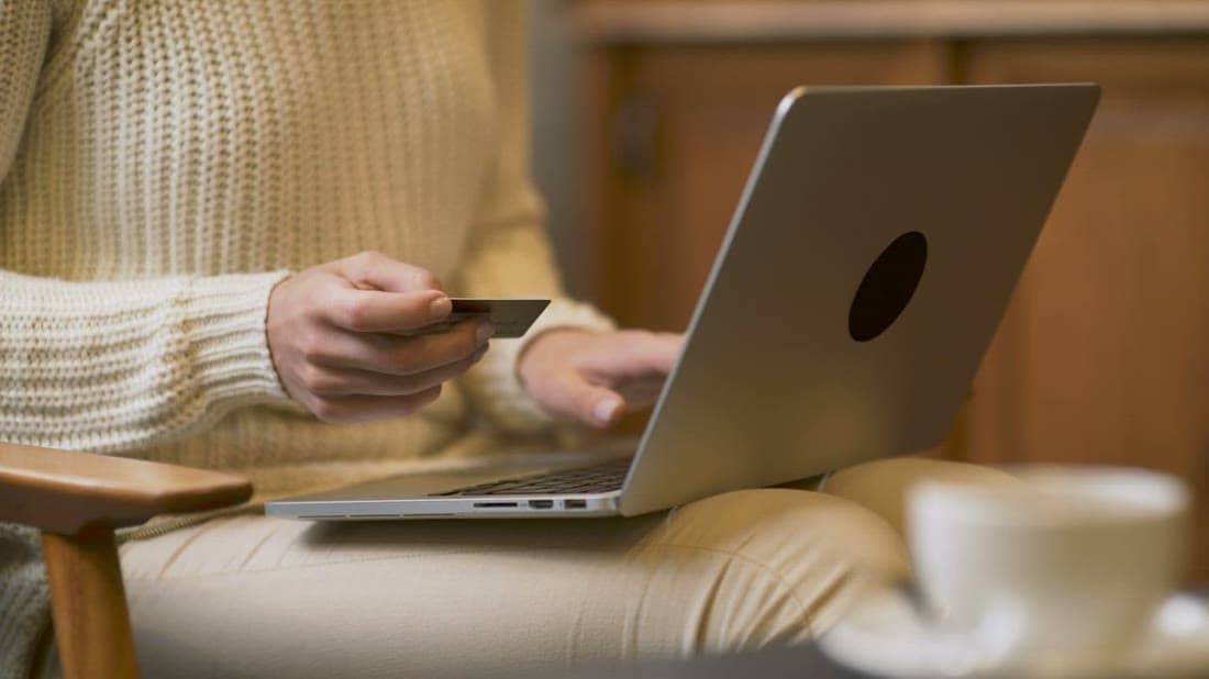 Shopper paying online with a credit card on a laptop